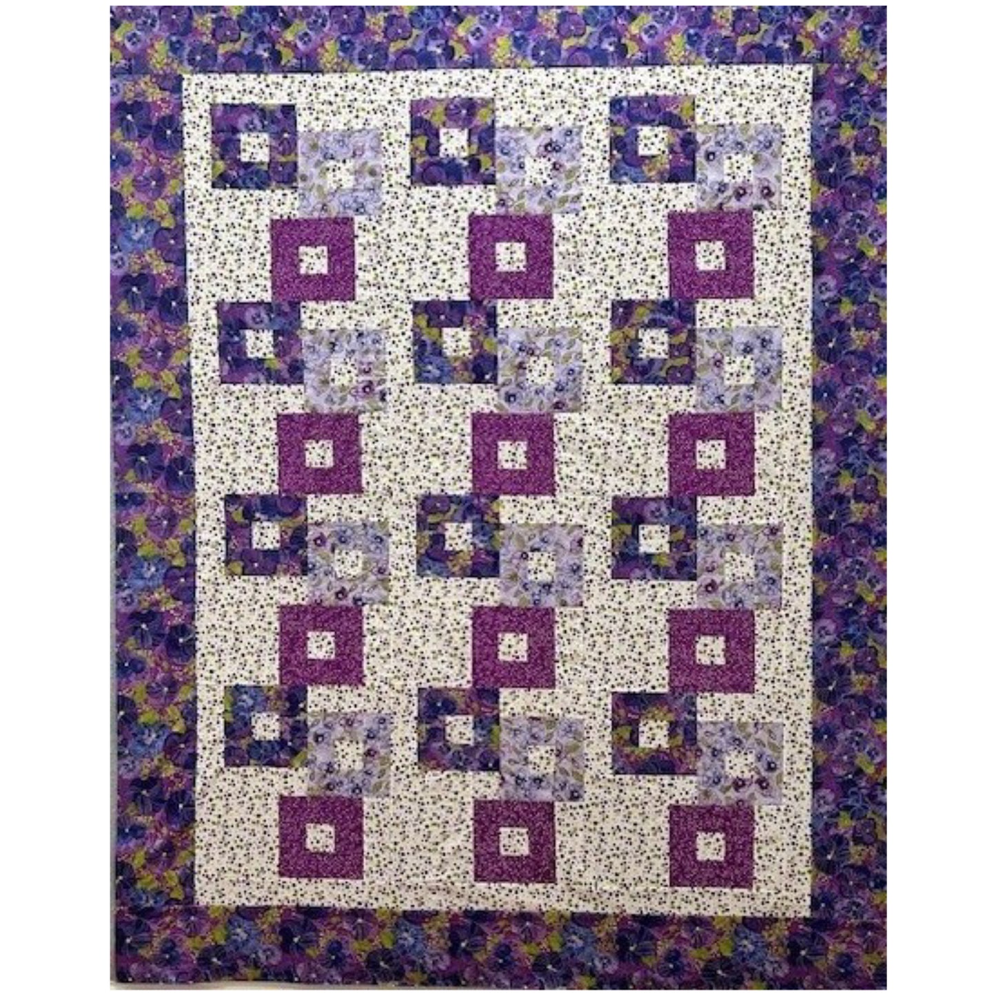 Colorful stacked blocks with opening quilt with floral prints in purples.