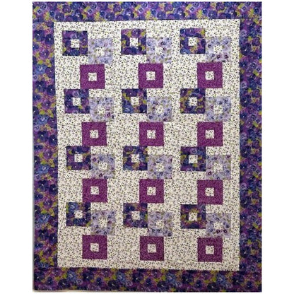 Colorful stacked blocks with opening quilt with floral prints in purples.