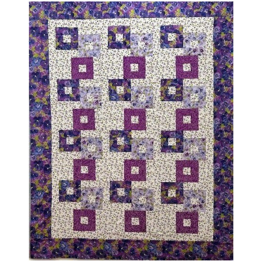 Colorful stacked blocks with opening quilt with floral prints in purples.