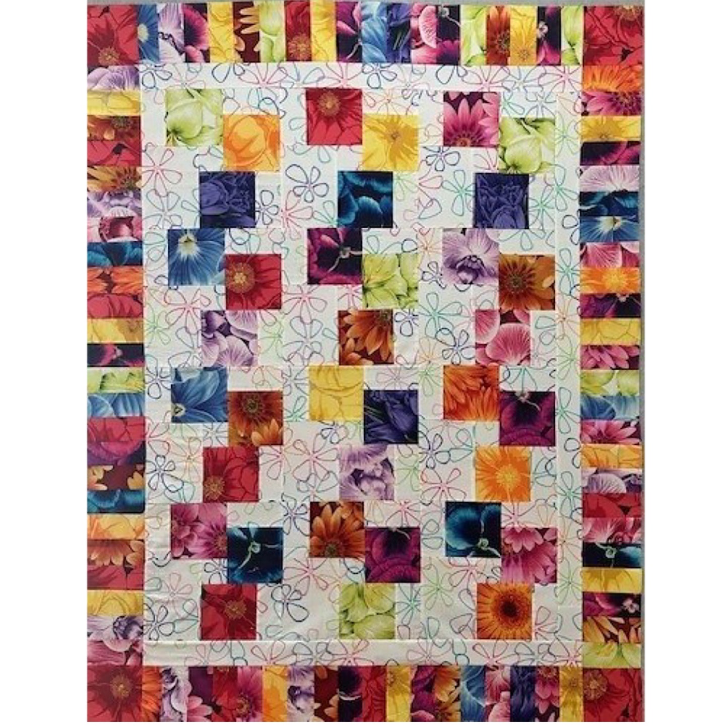 Colorful stacked blocks quilt with floral prints in bright colors.