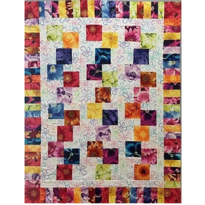 Colorful stacked blocks quilt with floral prints in bright colors.