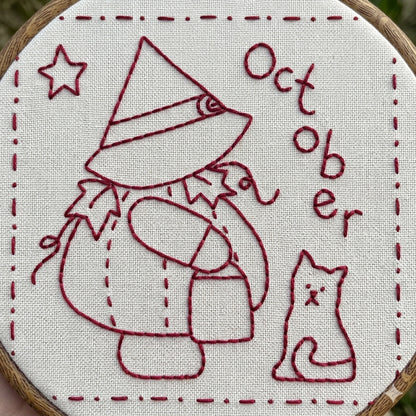 Sunbonnet Sue redwork design featuring sunbonnet sue in a pumpkin costume and witches hat. 