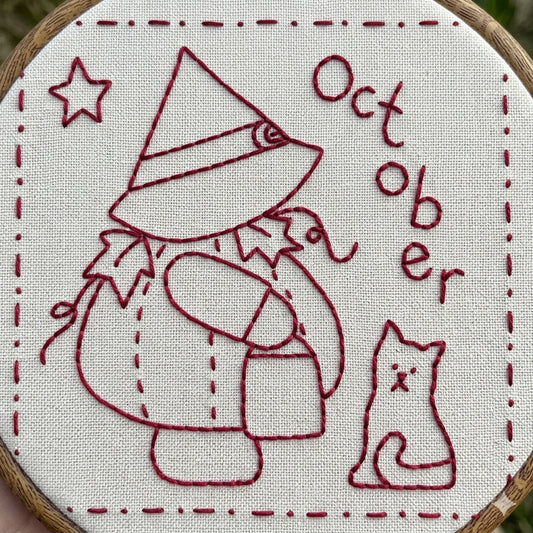 Sunbonnet Sue redwork design featuring sunbonnet sue in a pumpkin costume and witches hat. 