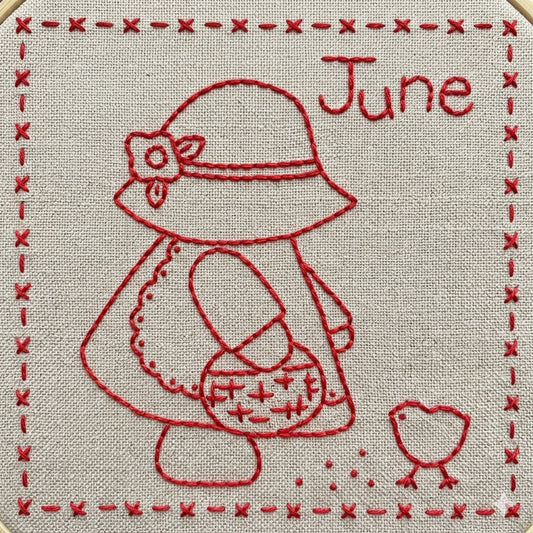 Sunbonnet Sue embroidery design for June that features Sunbonnet Sue with her basket and spreading feed for a cute baby chick.