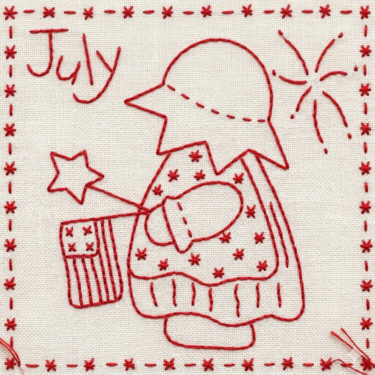 Red folk-style embroidery on cream fabric, featuring Sunbonnet Sue in a hat holding a star and a small American flag, with the word "July" and a starburst motif.
