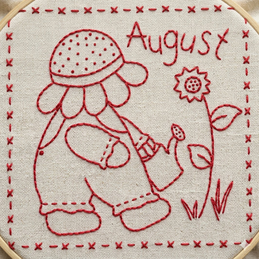 Redwork design featuring Sunbonnet Sue watering flowers while wearing a sunflower hat.