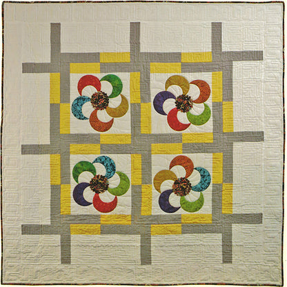 Coin Ruched Blossom embellished applique pinwheels are pieced into modern style sashing in this fun Pinwheel Spinner quilt