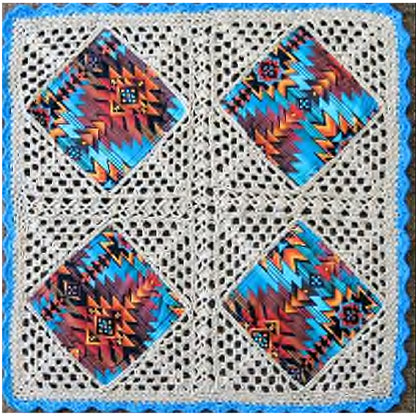 Beautiful center piece crocheted quilt features diamonds of colorful fabric crocheted together in a neutral cream thread. Four blocks complete this center piece with a blue crocheted border to pull it all together.