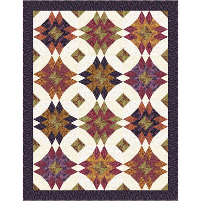 A colorful quilt featuring a quilted patchwork design with a prominent star pattern throughout.