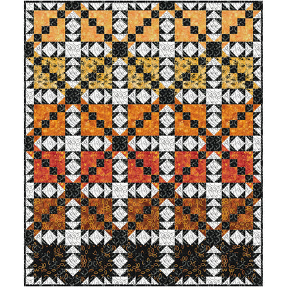 quilt combines bold geometric blocks with lively movement and rich batik textures. The alternating blocks create a playful secondary design, while dramatic black-and-white accents frame warm golden, amber, and honey-inspired fabrics, giving the quilt depth and sparkle.
