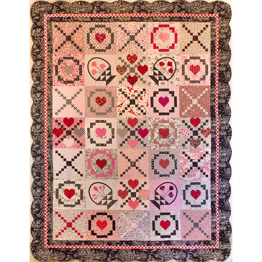 Pretty pink quilt with Xs and Os like kisses and hugs with some flower blocks. Adorable for Valentine's day.