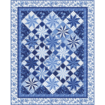 Beautiful quilt features blue fabric and diamonds of star motifs.