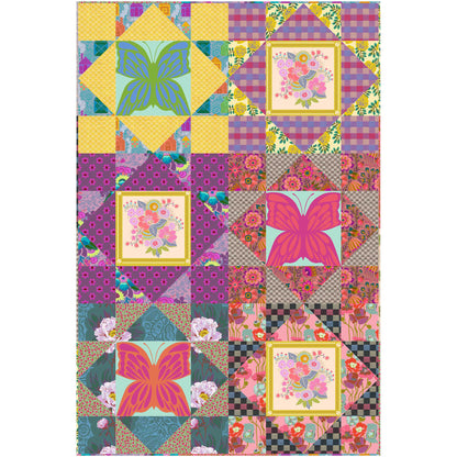 Bright quilt features blocks of different fabrics some with a four patch and some with a large print.