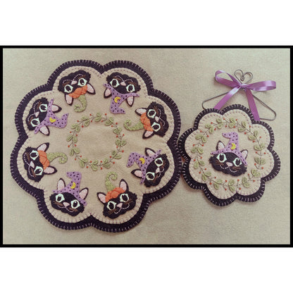 These adorable Halloween kitties are dressed in fun costumes and ready for Trick or Treating on this table mat and matching ornament.
