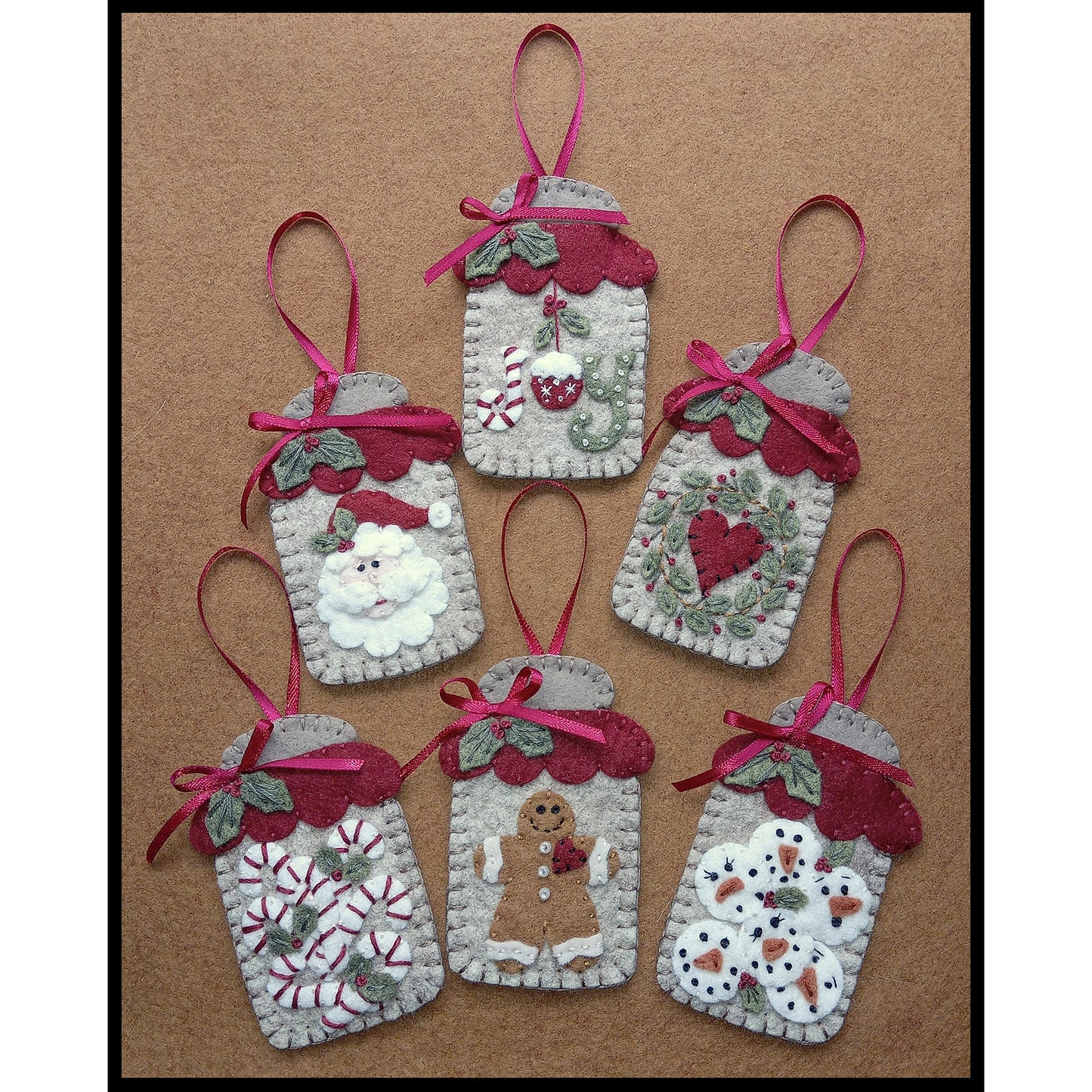 The sweetest little wool applique canning jars to decorate your home with this holiday season! Inside include the words "Joy", heart with wreath, snowmen faces, Santa face, candy canes and a gingerbread man.