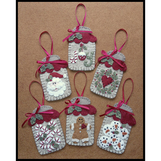 The sweetest little wool applique canning jars to decorate your home with this holiday season! Inside include the words "Joy", heart with wreath, snowmen faces, Santa face, candy canes and a gingerbread man.