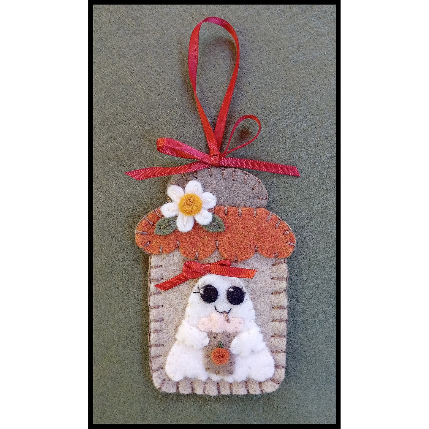 Adorable mason jar ornament using wool felt shown close up with a cute ghost with a bag for candy.