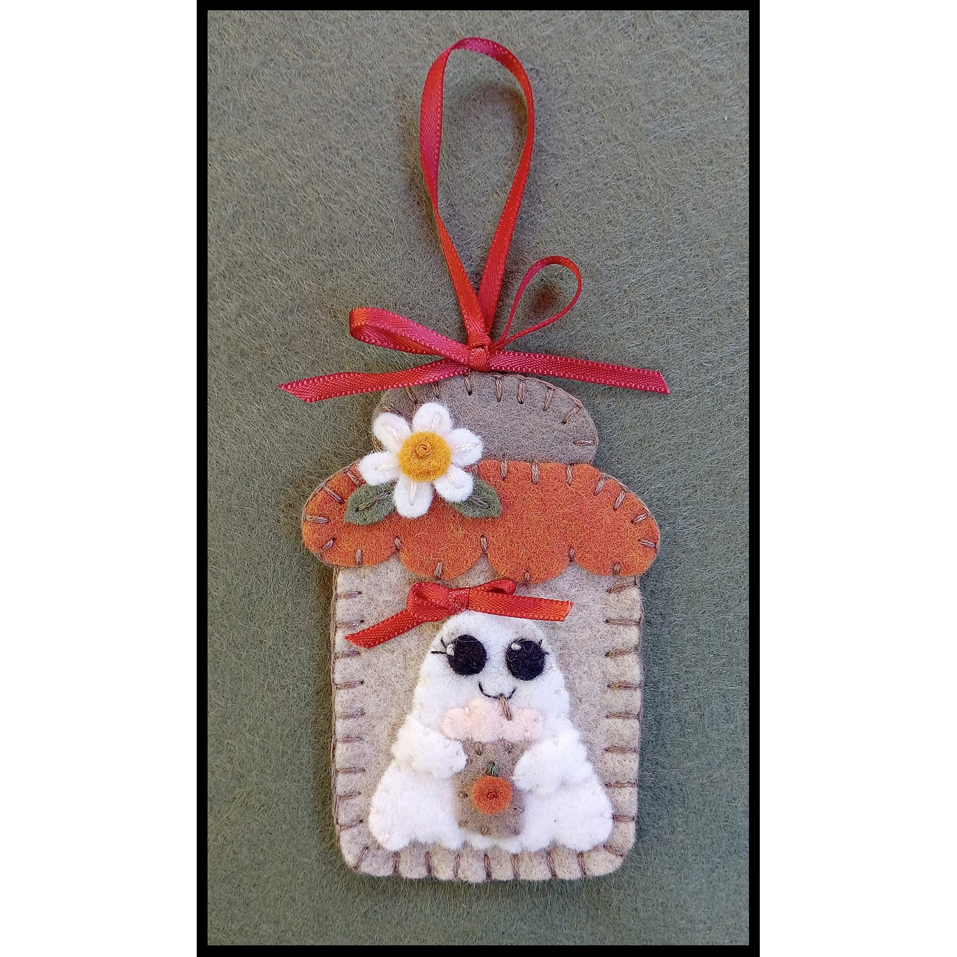 Adorable mason jar ornament using wool felt shown close up with a cute ghost with a bag for candy.