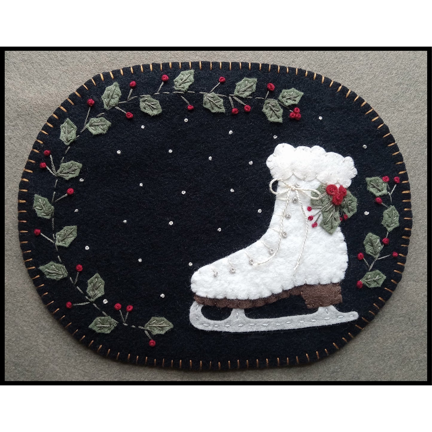 Adorable, winter Snow Day candle mat or mug rug features holly, snowflakes and an ice skate.