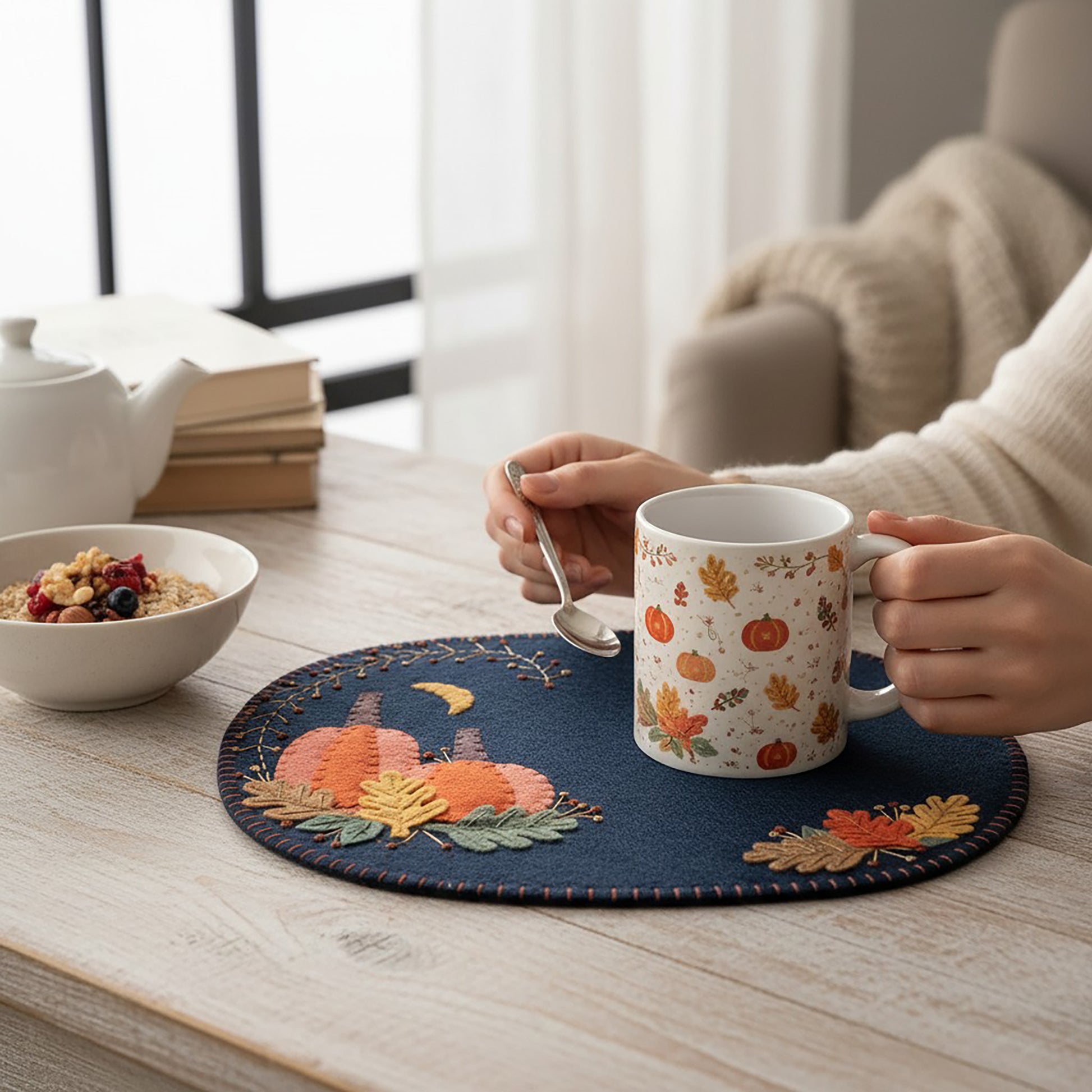 Bring the beauty of Autumn into your home with this lovely mug rug/table mat. It's the perfect size to rest a cup of coffee, tea or cider on! It features pumpkins and colorful leaves.