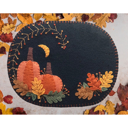Bring the beauty of Autumn into your home with this lovely mug rug/table mat. It's the perfect size to rest a cup of coffee, tea or cider on! It features pumpkins and colorful leaves.