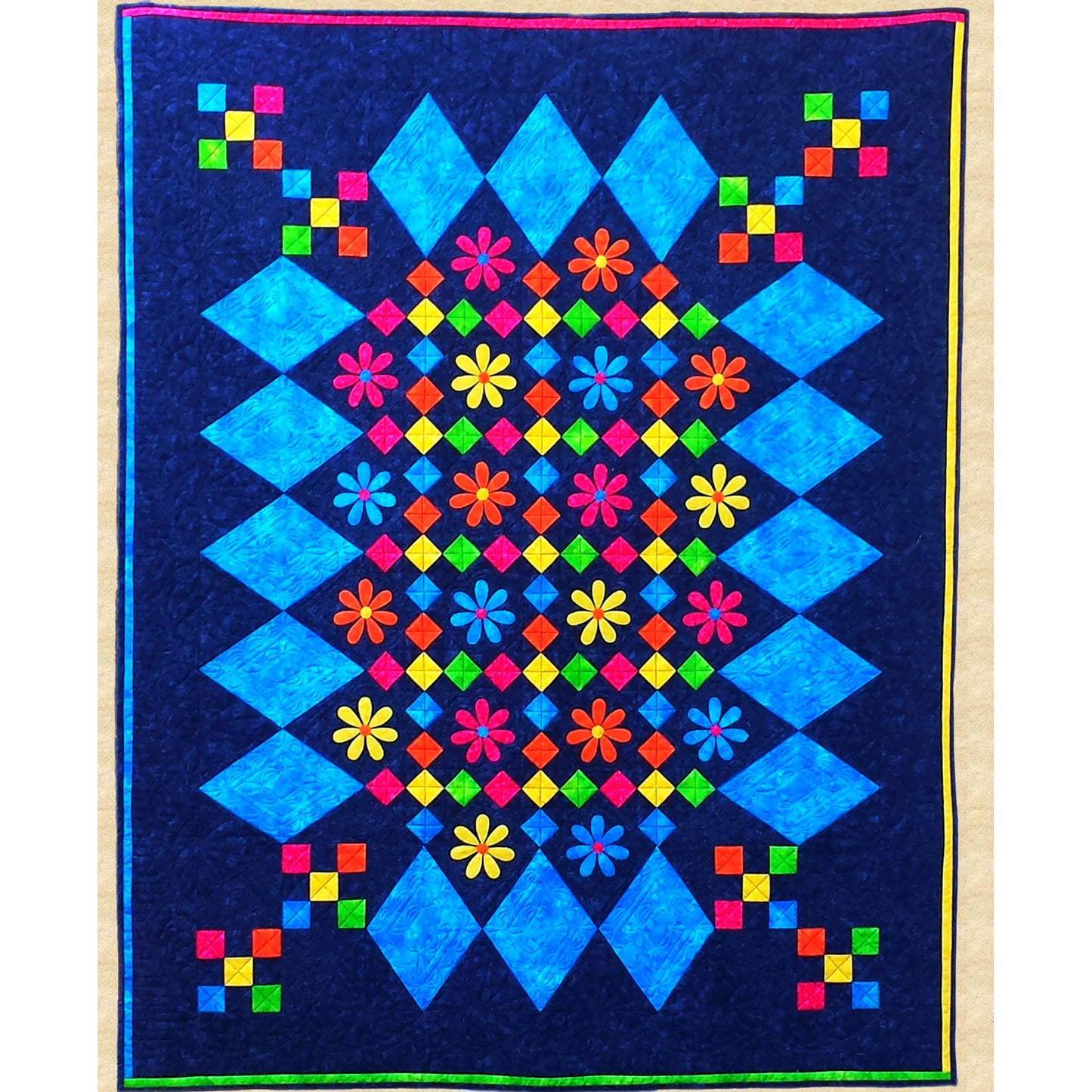 Bright and fun quilt features diamonds of light blue border with bright colored flowers and diamonds inside with a few nine-patch of five bright colors bleeding into the corners. 