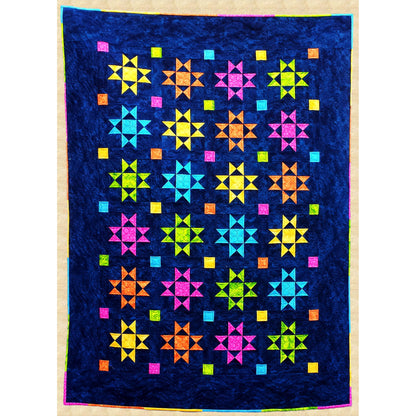 Traditional Ohio Star blocks in bright colors sparkle against a dark blue night sky in this cozy quilt. The multicolor binding picks up the star colors for a creative finish.