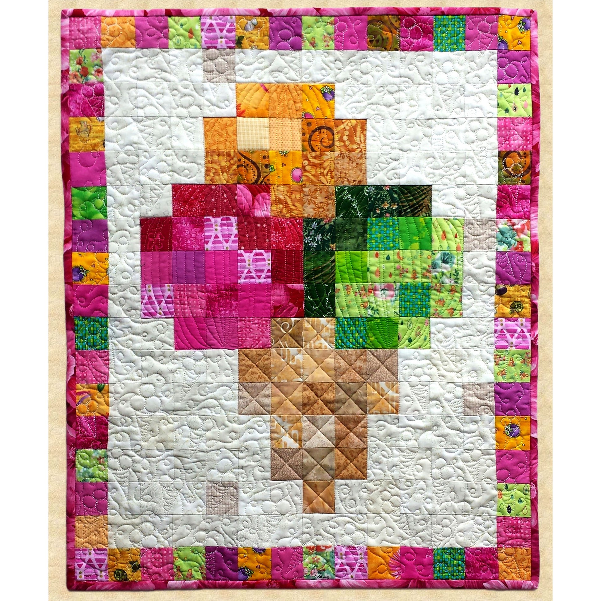 Colorful quilt with a geometric ice cream cone pattern on a white background by Pumpkin Patch Patterns. 