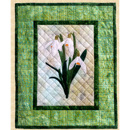 Fusible applique wall hanging quilt features a snowdrop flower in the middle.