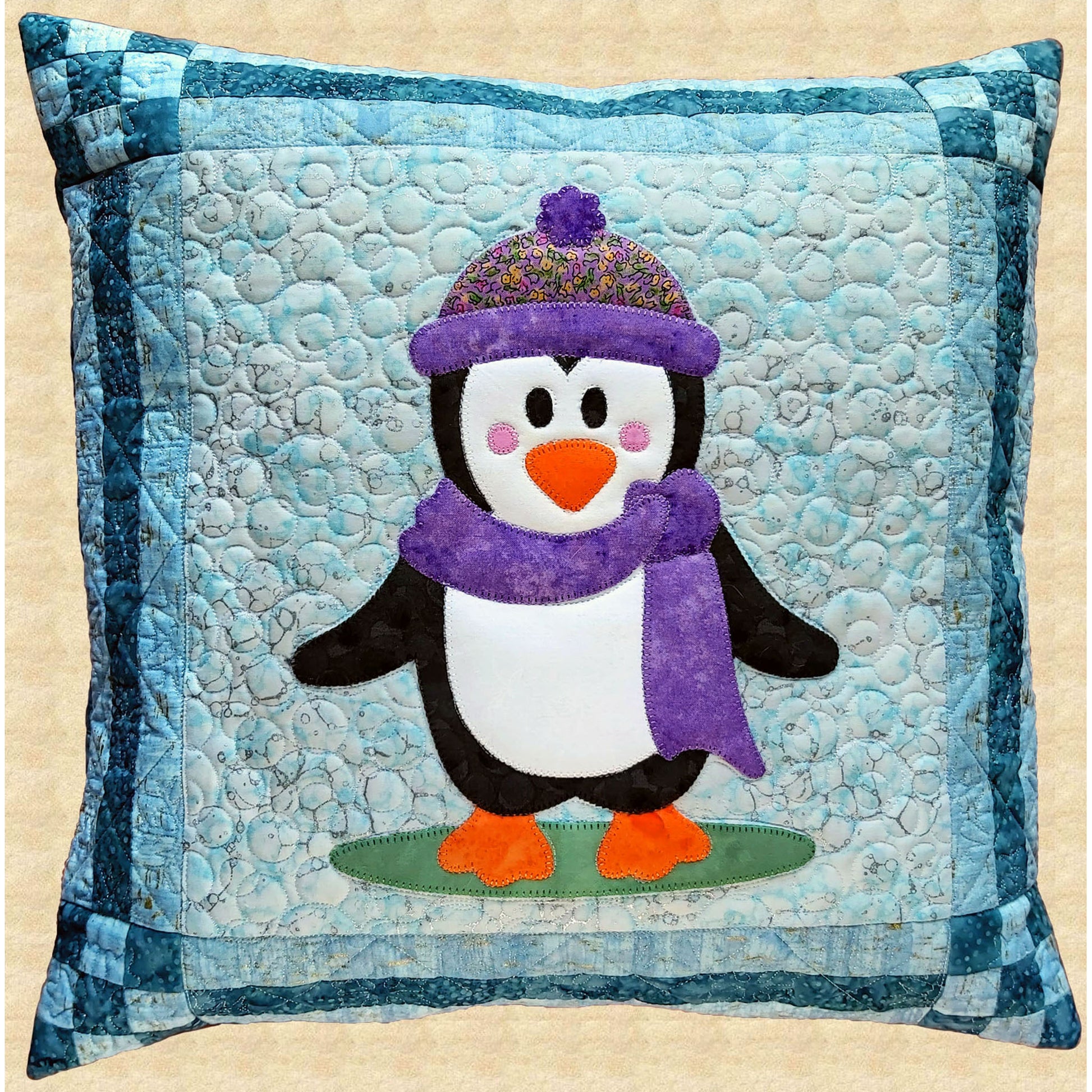 Adorable pillow shown quilted and featuring an adorable penguin wearing a hat and scarf.