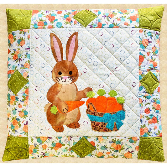 A sweet appliqué bunny with a basket of carrots takes center stage in this inviting pillow.