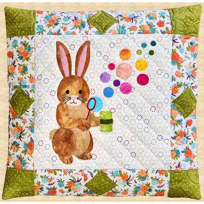 An appliqué bunny blowing bubbles creates a whimsical focal point in this pillow.