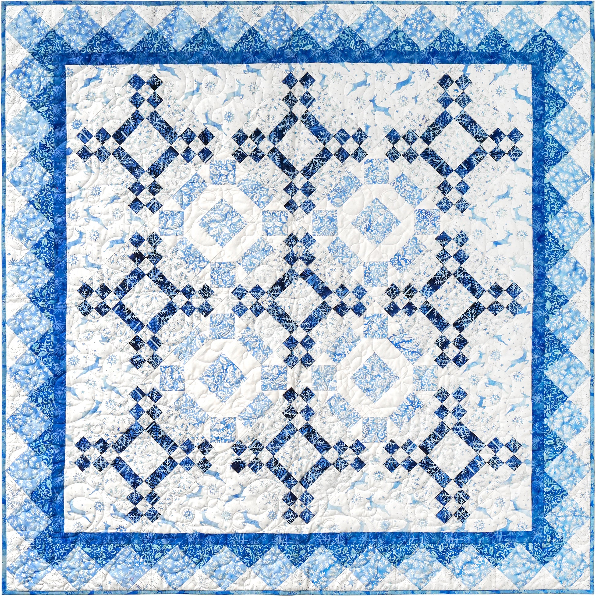 A blue and white quilt featuring a classic square design which looks like maybe snowflakes.