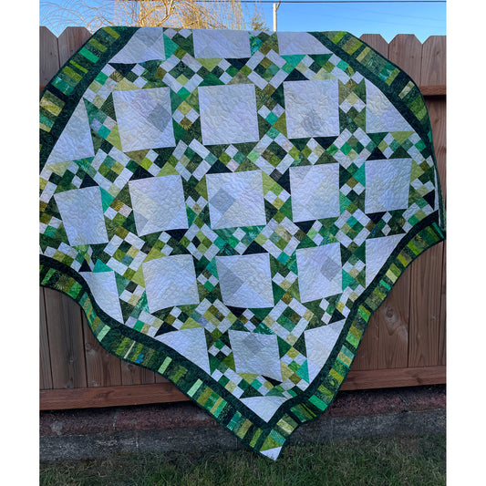 Jacob's Well quilt is a fun geometric quilt with blocks at diagonals with patched background colors diamonds.