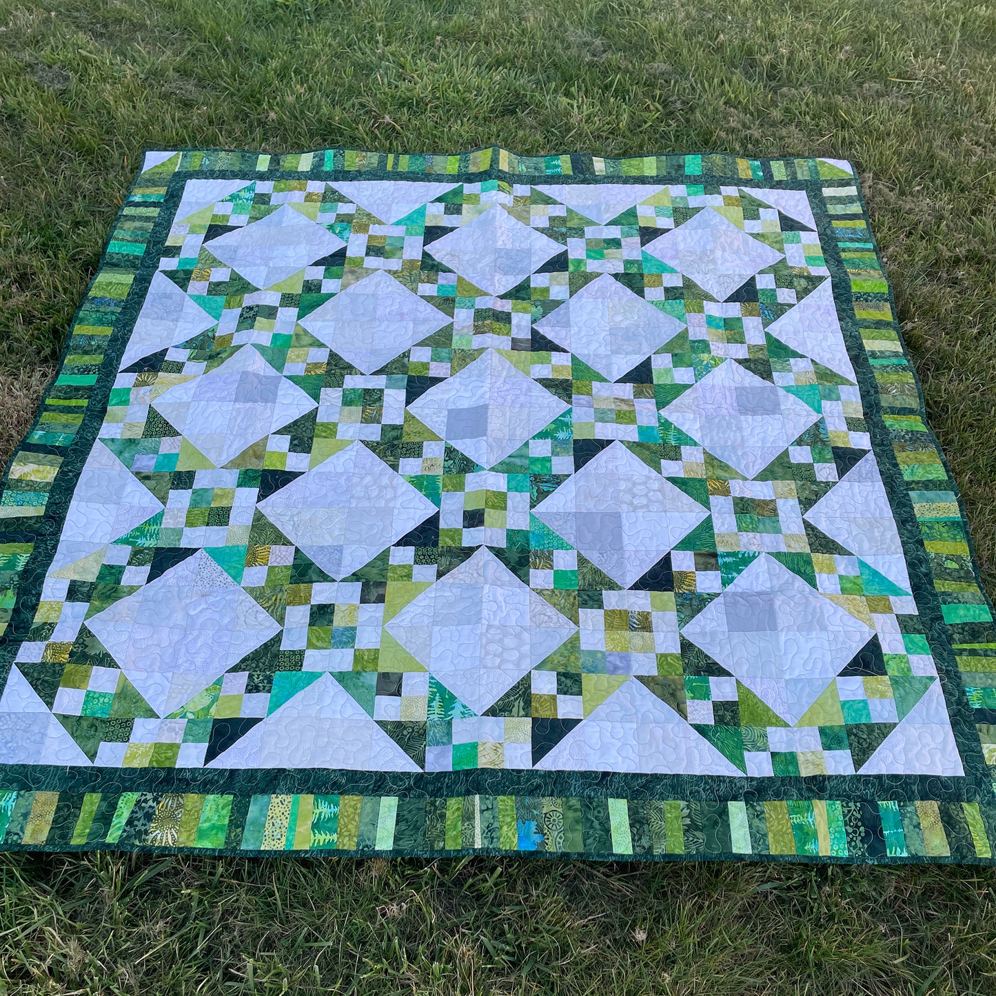 Jacob's Well quilt is a fun geometric quilt with blocks at diagonals with patched background colors diamonds.