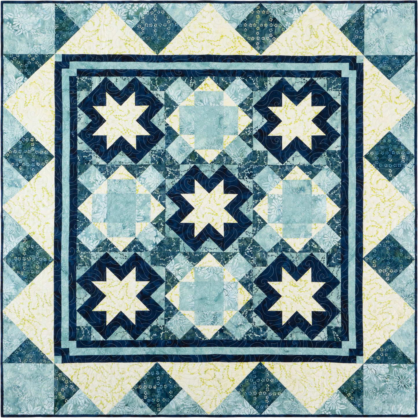 This quilt has a traditional, symmetrical layout with a wintery, frosty feel thanks to the cool blues and soft yellows in the fabrics. It features a three-by-three layout using two alternate blocks, giving it a mosaic look. 
