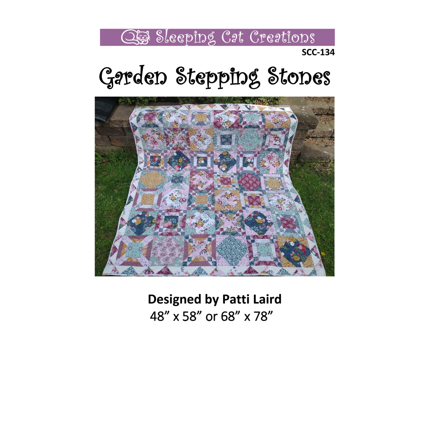 Quilt with garden stepping stone pattern on grass, labeled 'Sleeping Cat Creations'.