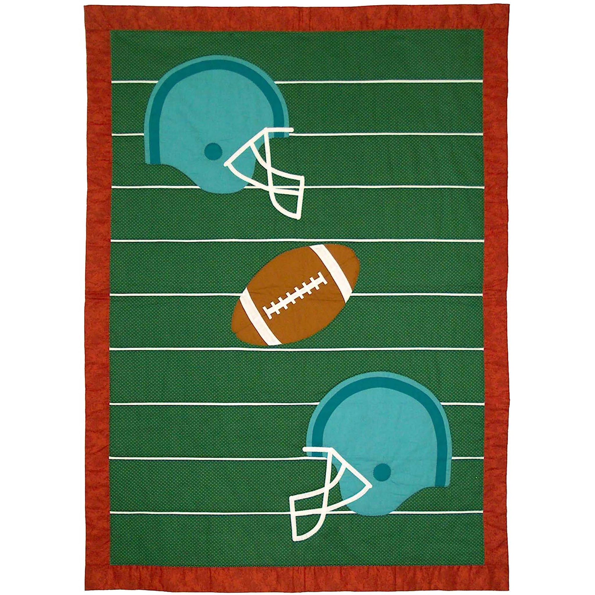 Crib-sized quilt with football field with lines on green with a football in the middle and two helmets.