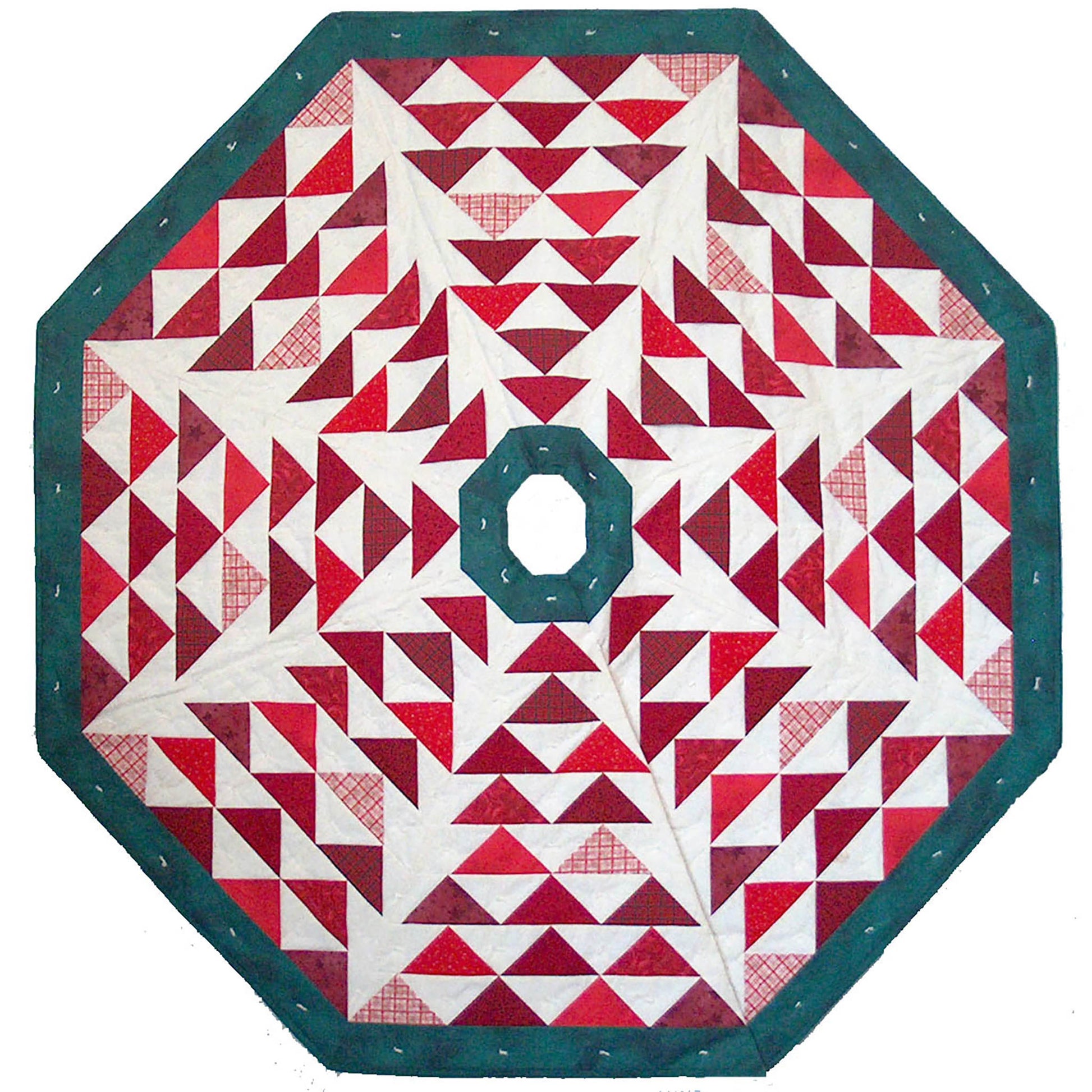 Tree skirt with triangles in red (that could have been green and look more like Christmas trees) with green border and cream or tan background color.