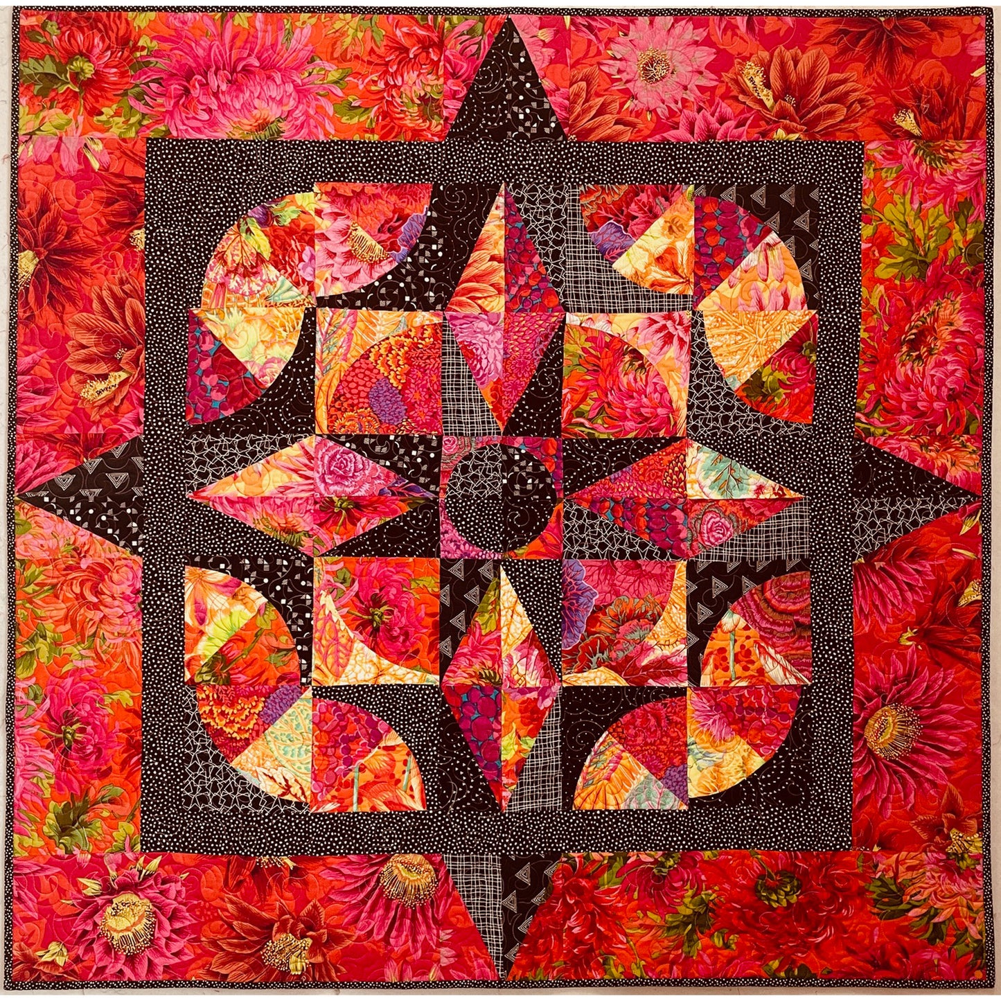 Colorful quilt with a star design on a floral background