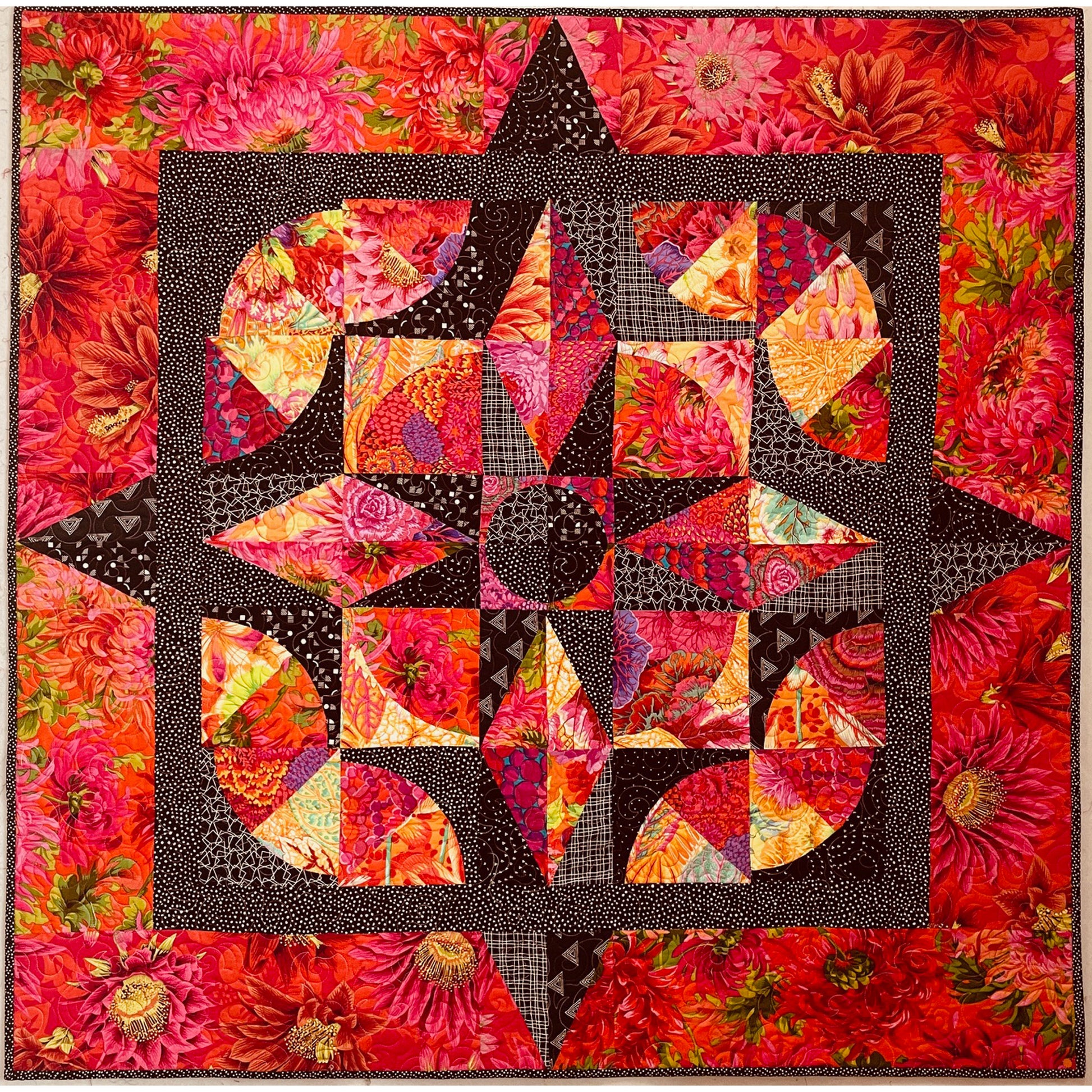 Colorful quilt with a star design on a floral background