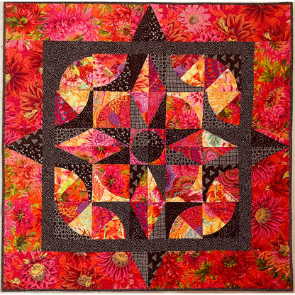 Colorful quilt with a star design on a floral background