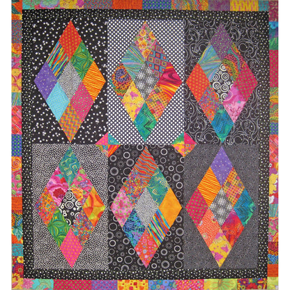 You will put a sparkle in someone's eye when you present them this quilt with the background in a variety of black and white prints, the diamonds pop right off the quilt with their bright colors.