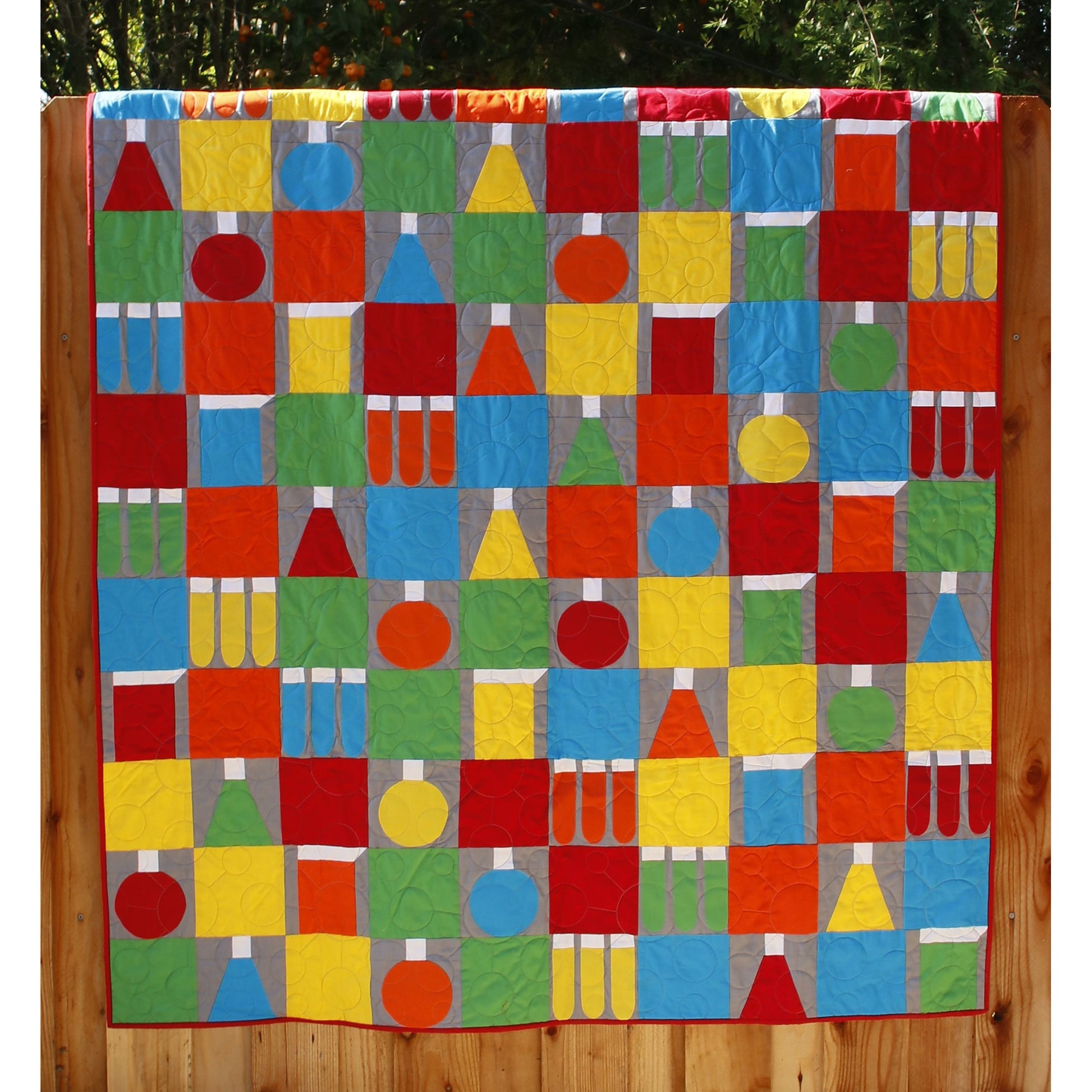 A science lab on a quilt.  Blocks of colorful beakers.