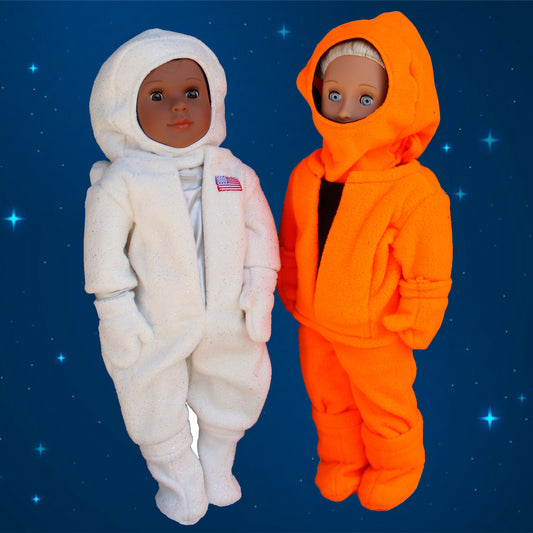 Two dolls in space suits against a starry space background