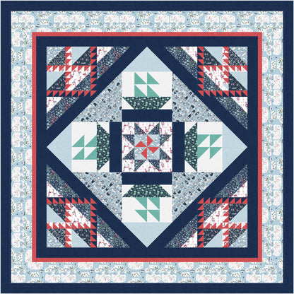 Quilt with geometric pattern on a blue floral background