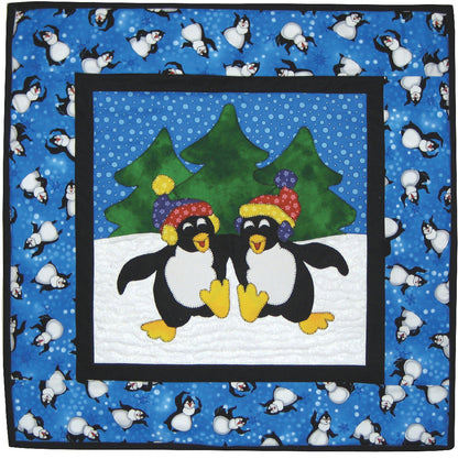 Adorable winter quilt with penguins arm in arm in the snow with hats on. 