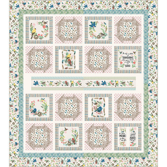 Sunshine and Song quilt features a bird study panel cut up with matching fabric of churn dash blocks and blocks with panel blocks. The theme of the fabric is birds with a long printed panel piece in the middle.