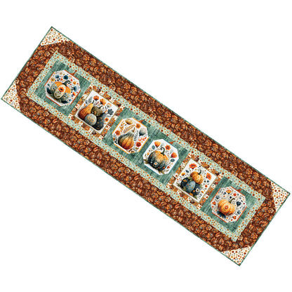 Festive table runner with blocks of pumpkins or gords with flowers. Beautiful fall decoration.