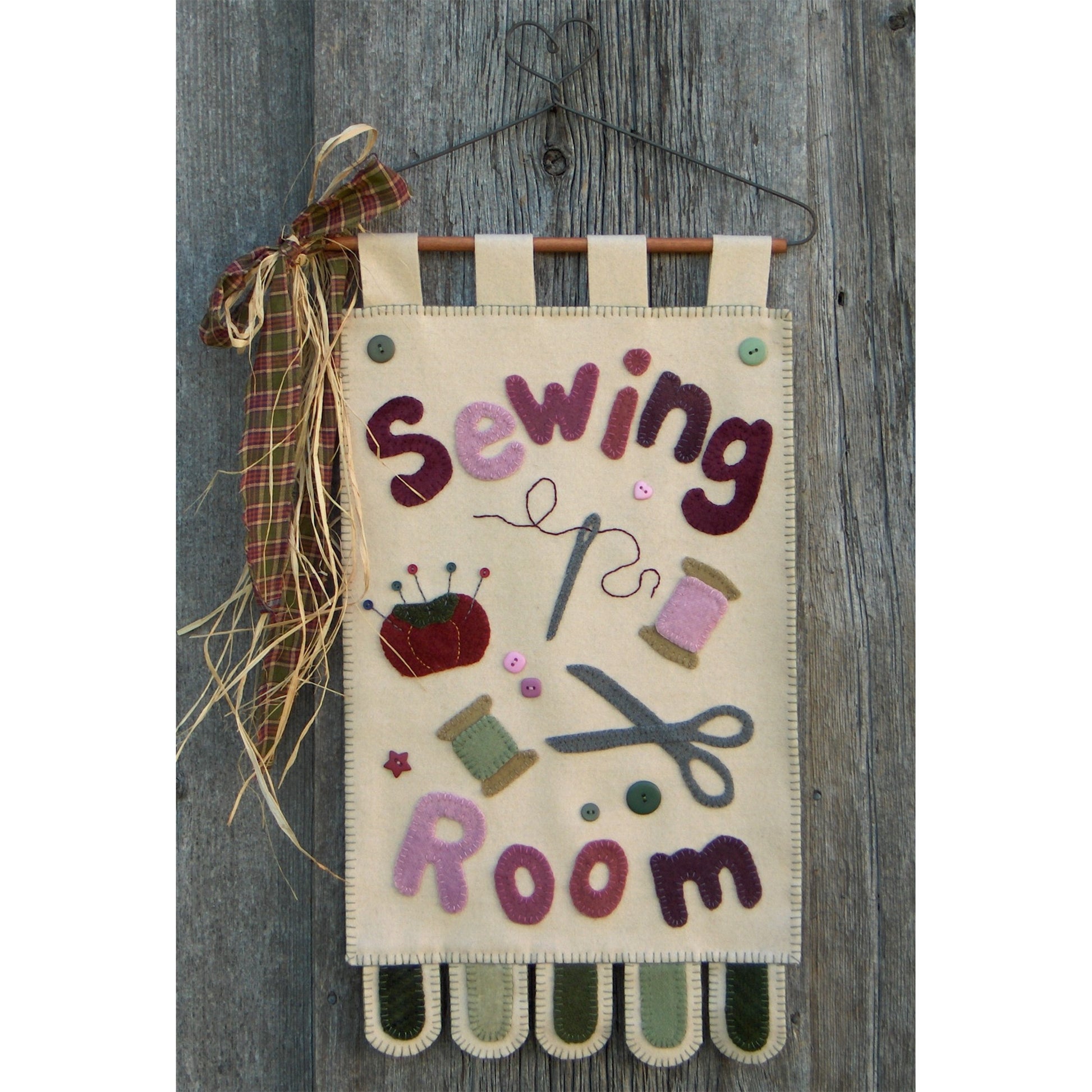 Decorative sign with 'Sewing Room' text and sewing-themed illustrations on a wooden background.